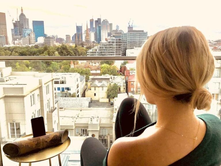 woman on balcony overlooking city