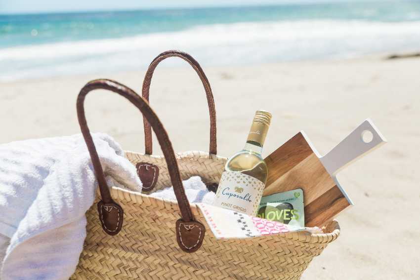 Pinot Grigio wine in a basket on the beach